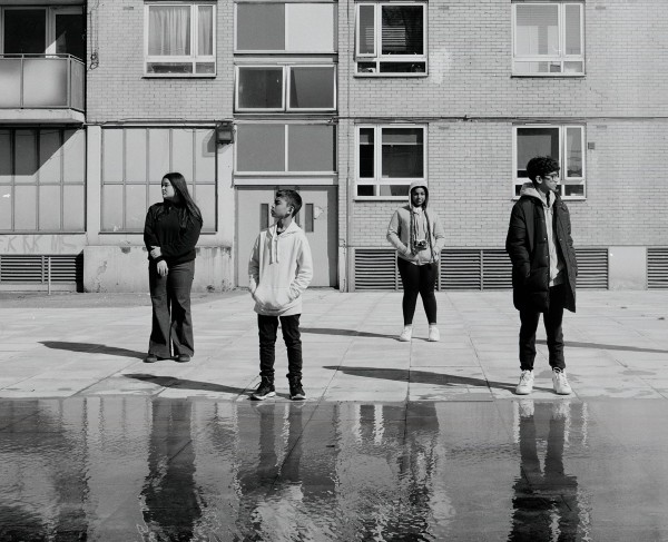 Four young people looking at their surroundings.